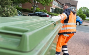 Aha Mitarbeiter zieht großen Müllcontainer